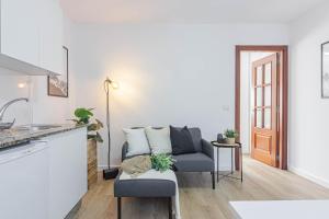 a kitchen and living room with a couch and a table at Terreo 10-12 in A Coruña