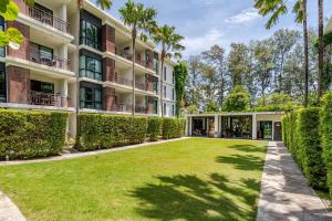 an exterior view of a building with a yard at Title III and II by Villacarte in Rawai Beach