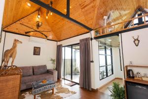 a living room with a couch and a tv at Sinsup villa Mountain View 1 in Ban Huai Khai