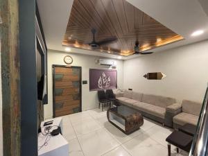 a living room with a couch and a table at Hotel Hari Om in Diu