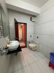 a bathroom with a sink and a toilet at Hotel Hari Om in Diu