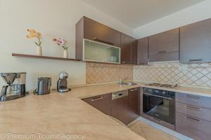 a kitchen with wooden cabinets and a counter top at Villa Mia in Kustići +43 photos