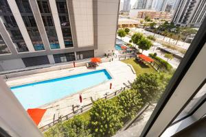 a view of a swimming pool from a building at Reem Island Modern 1BR Pool, Gym, City View in Abu Dhabi