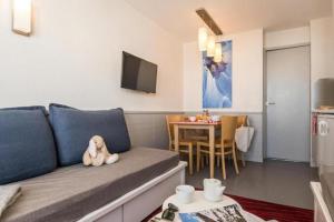 a living room with a couch with a stuffed animal at Résidence Antarès - Avoriaz in Morzine