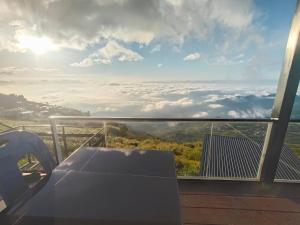 a room with a table and a view of clouds at ไร่ผางาม ภูทับเบิก in Ban Maeo Thap Boek