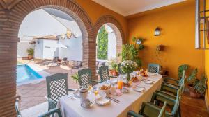 a dining room with a table and a pool at Villa el Señorío Alameda by Ruralidays in Antequera