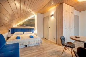 a bedroom with a bed and a wooden ceiling at Pokoje Marta in Międzybrodzie Bialskie