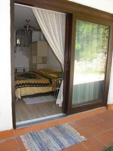 a bedroom with a bed and a sliding glass door at Apartments Darinka in Opatija