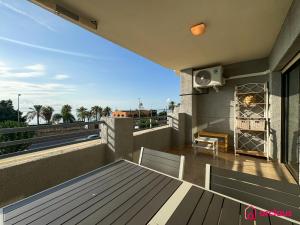 a balcony with a view of the ocean on a house at El Apartamento in Benicàssim