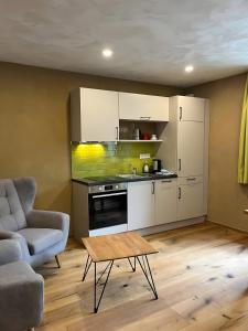 a kitchen with a couch and a table in a room at Bio Bausewein - Studio 1 in Iphofen