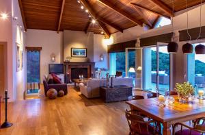 a living room with a couch and a table at Villa Laurette Kratigos - Private Escape with Views in Pligónion