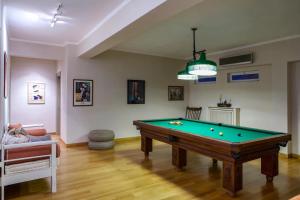 a living room with a pool table and a couch at Villa Laurette Kratigos - Private Escape with Views in Pligónion