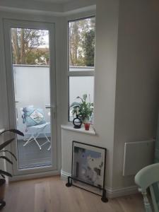 a living room with two windows and a chair at Beautiful flat in the heart of South London in London