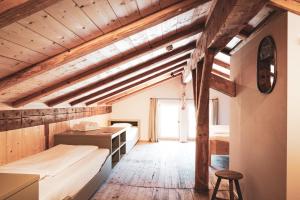 a room with two beds and a desk and a chair at STUBN in der Frasdorfer Hütte in Frasdorf