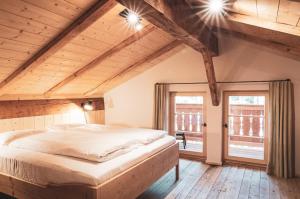 a bedroom with a large bed in a attic at STUBN in der Frasdorfer Hütte in Frasdorf