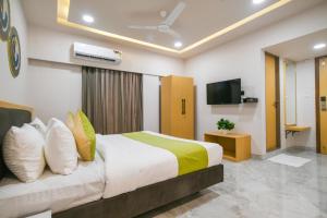 a hotel room with a bed and a television at The Byke Express - Near Gopur Square in Indore +66 photos
