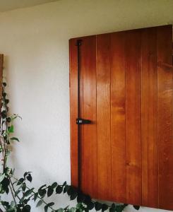 a wooden cabinet in the corner of a room at Apartmani Perić in Bar