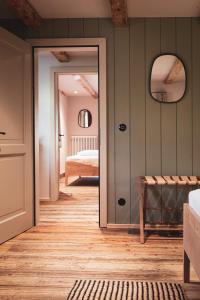a bedroom with a door leading to a bed at STUBN in der Frasdorfer Hütte in Frasdorf