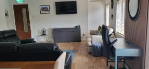 a living room with a couch and a table at Cathedral View Apartment Derry in Londonderry County Borough +36 photos