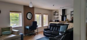 a living room with a couch and a chair at Cathedral View Apartment Derry in Londonderry County Borough