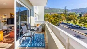 a balcony with a table and chairs and a view at The Pearl in the Winelands in Paarl