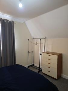a bedroom with a bed and a dresser in it at Colchester Y5 in Hythe