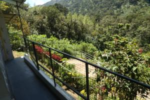a balcony with a view of a garden at Snow drops homestay in Kallar Vattiyar