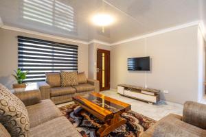 a living room with a couch and a tv at Haven House in East London