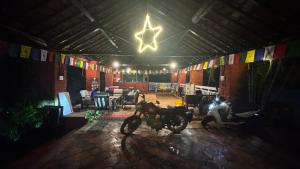 a garage with a motorcycle parked in a room with flags at River Edge Resort & Café in Kumta