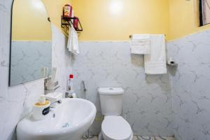 een badkamer met een wit toilet en een wastafel bij Shwari Home Stays in Kisii