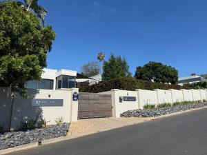 a white building with a fence and a street at 14 Wylant Street in Welgemoed