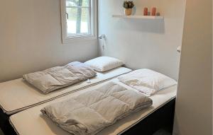 two beds sitting next to each other in a room at Pet Friendly Home In Vestervig With Sauna in Tåbel
