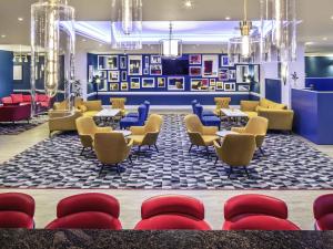 a lobby with chairs and tables and a waiting room at Mercure Swansea Hotel in Swansea