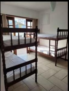 a room with two bunk beds and a table at Hostel da Dani in Balneário Camboriú