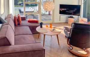 a living room with a couch and a table at 3 Bedroom Gorgeous Home In Hurup Thy in Doverodde +12 photos