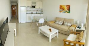 a living room with a couch and a table at Aguycan - Bungalow with ocean views in San Bartolomé