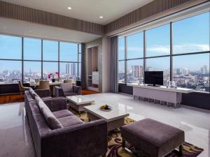a living room with a view of a city at Grand Mercure Jakarta Harmoni in Jakarta