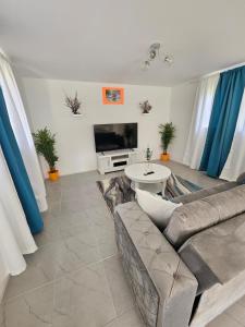 uma sala de estar com um sofá e uma TV em Raven's Casa del Mar em Willemstad