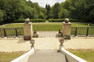 a walkway leading to a gate in a garden at Southcrest Manor Hotel, Best Western Signature Collection in Redditch