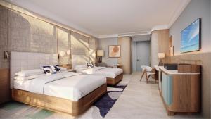 a hotel room with two beds and a desk at The Westerly At Hilton Aruba Caribbean Resort in Palm-Eagle Beach