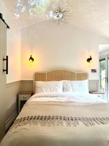 a bedroom with a bed and a chandelier at Alum House Littlebeck, Whitby - Roe Deer Lodge in Sleights