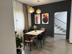 a dining room with a table and chairs at PINE HOUSE 2023 in Vlorë