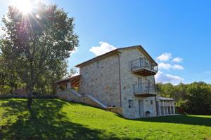 an old stone house on a grassy hill at Villa Krug with 3 br and a pool immersed in nature near Buje in Kremenje