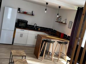 a kitchen with a counter and a refrigerator at Beachfront Studio in Marigot +4 photos