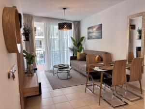 a living room with a table and a couch at Poseidon 6 - cozy apartment with swimming pool in Puerto de Santiago