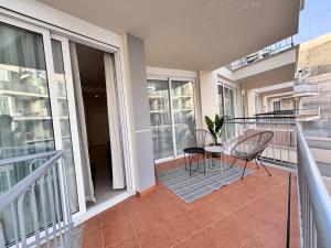 a balcony with a table and chairs on it at Poseidon 6 - cozy apartment with swimming pool in Puerto de Santiago