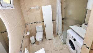 a small bathroom with a toilet and a sink at Poseidon 6 - cozy apartment with swimming pool in Puerto de Santiago