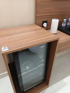 a microwave sitting under a wooden counter with at فندق مكين in Al Madinah