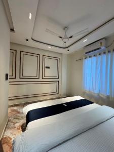 a large bed in a room with blue curtains at Soulful Ghat By Fracspace in Varanasi