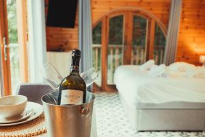 a bottle of wine in a bucket on a table at Robin Woodside Lodge in Caerwys
